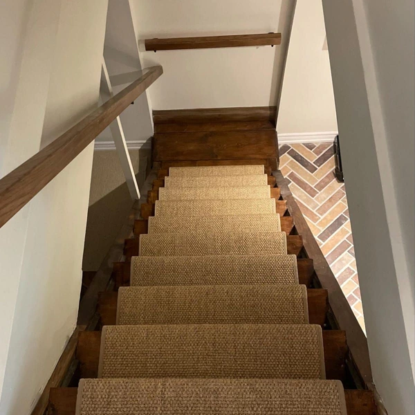 Sisal stair runner on rustic wooden stairs in apartment