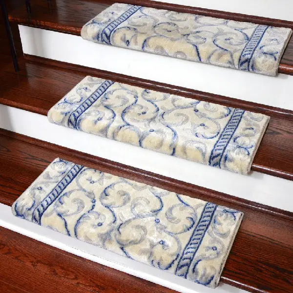 Beige and blue scroll-patterned carpet stair treads on dark wood steps