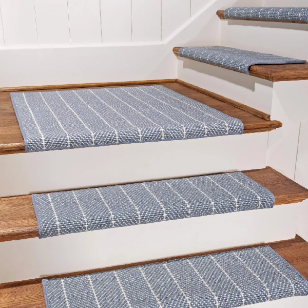 Blue patterned carpet stair treads on wooden steps