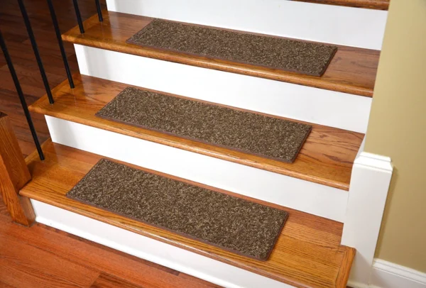 Brown patterned carpet stair treads on wooden steps