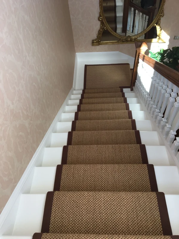 Brown sisal stair carpet runner with matching borders.