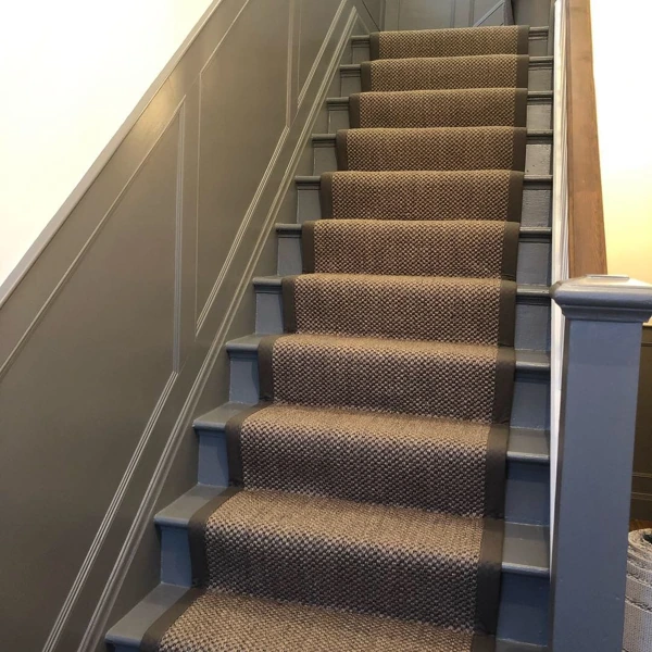 Brown sisal stair runner on painted grey staircase