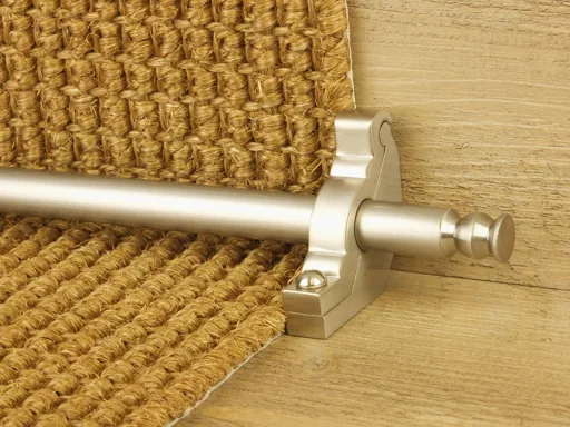 Brushed nickel stair rod on a woven natural fiber runner.