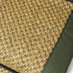 Close-up of Oriental natural sisal stair runner with olive green edging.