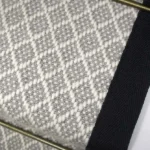 Close-up of Park Lane wool flatweave stair runner with black edging.