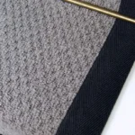 Close-up of a Charcoal Small Boucle Grey Wool Stair Runner with a black border.