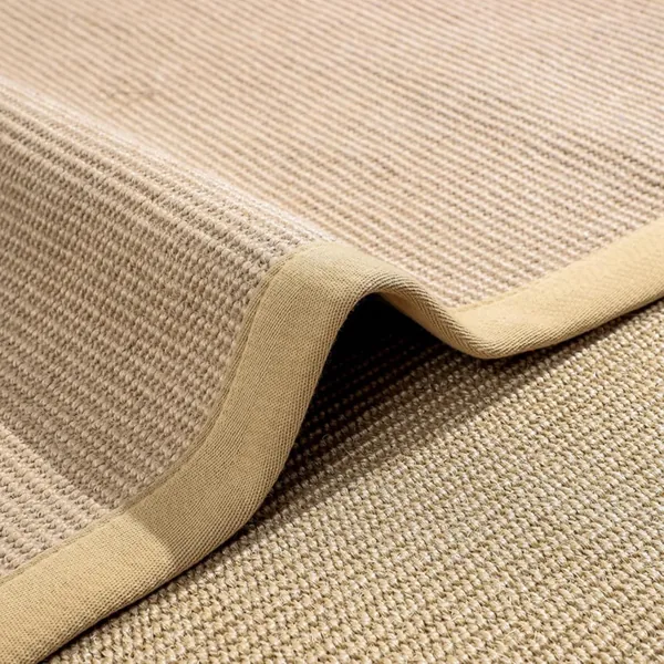 Close-up of beige sisal carpet with bound cotton edge