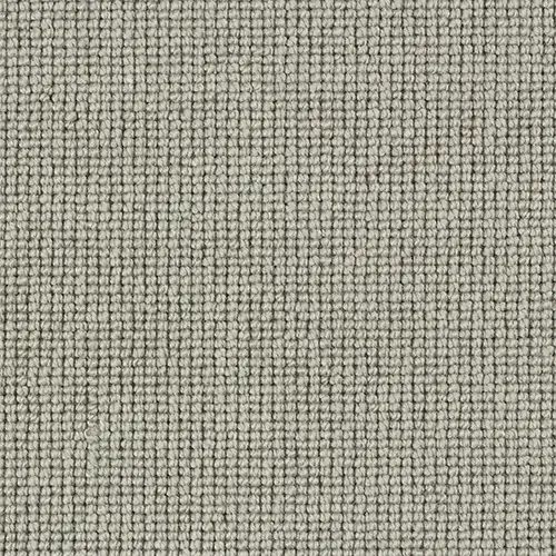 Close-up of textured grey-beige loop pile carpet fabric.