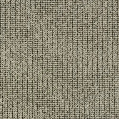 Close-up texture of grey-brown loop pile carpet in a grid pattern.