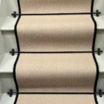 Fibre Flooring Highclere Wool Herringbone Stair Runner with a black border.