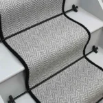 Fibre Flooring Lunar Herringbone Stair Runner with a black border.