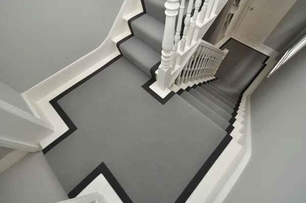 Grey wool stair runner with dark binding and landing border