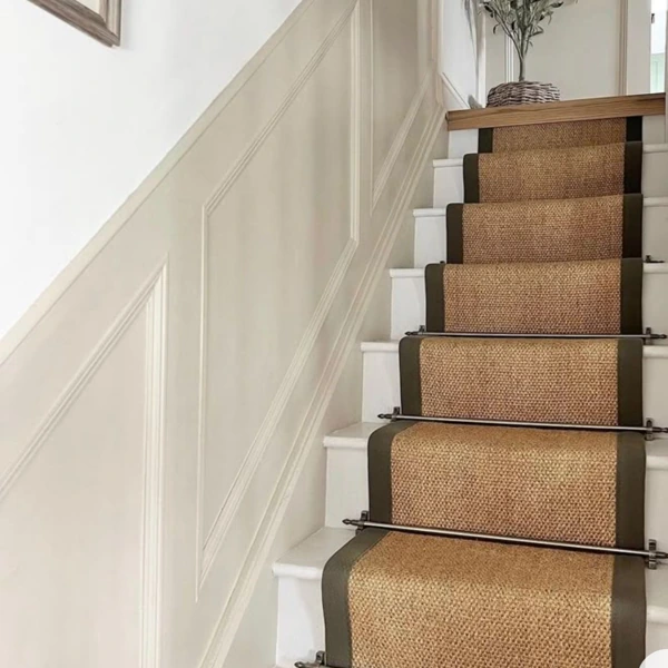 Natural sisal stair runner in a modern home entryway