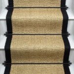 Honey Herringbone Sisal Stair Runner with a black border.