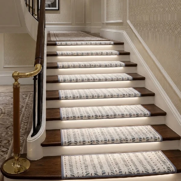 Light-colored, patterned carpet stair treads on dark wood steps