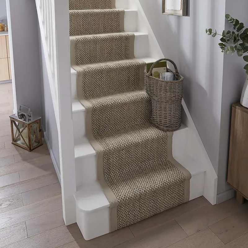 Light tan sisal stair carpet runner on white stairs