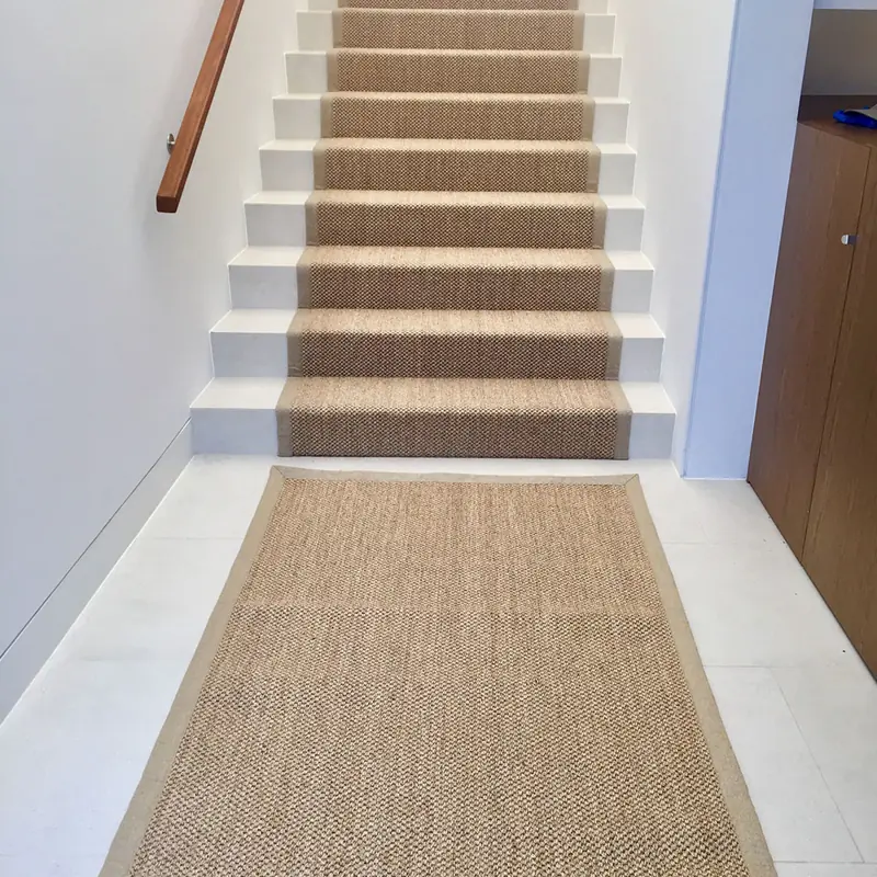 Matching sisal rug and stair runner on white steps