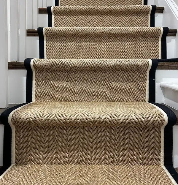 Natural herringbone stair runner with black and white binding.