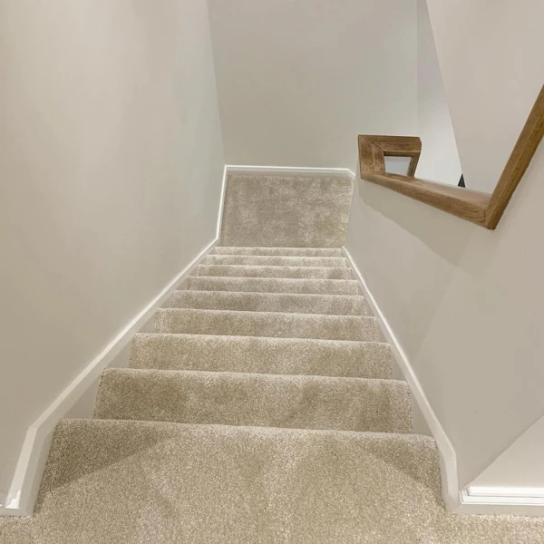 Neutral plush fully fitted carpet on home staircase
