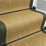 Oriental natural sisal stair runner with olive green edging and black stair rods.