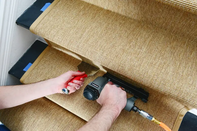 Securing stair carpet runner with staple gun tool