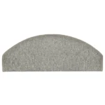 Semi-oval light grey carpet stair tread with bound edges.