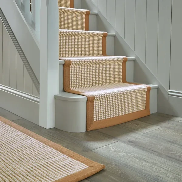 Cream and tan sisal wool blend carpet runner on stairs