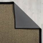 Taupe looped stair carpet with black border backing.