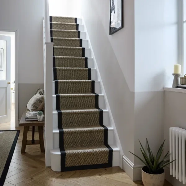 Taupe looped stair runner with black border.