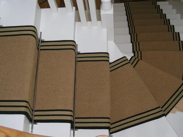 Textured natural-fiber stair runner with dark striped borders