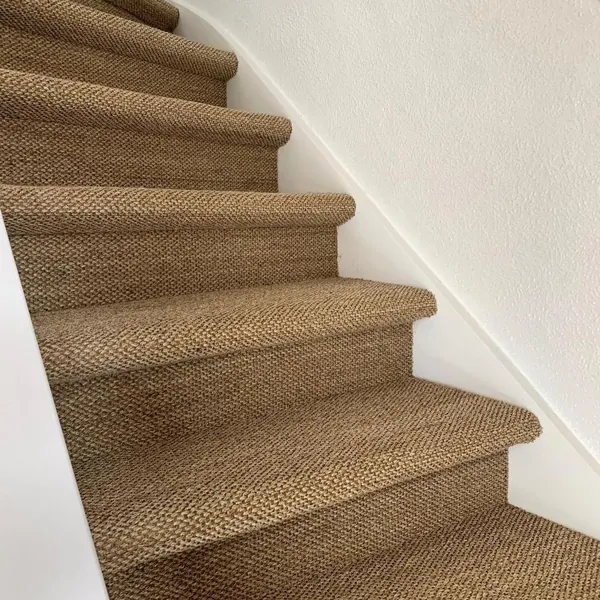 Natural tiger eye weave sisal carpet on white staircase