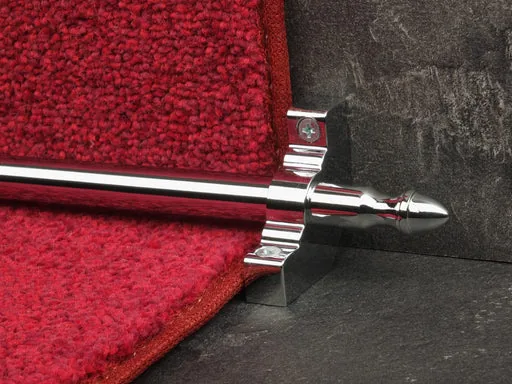 chrome stair rod with an acorn finial and mounting bracket securing a red loop-pile carpet