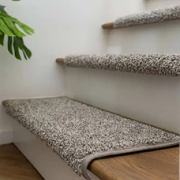 speckled gray and brown loop-pile carpet stair treads on wooden steps